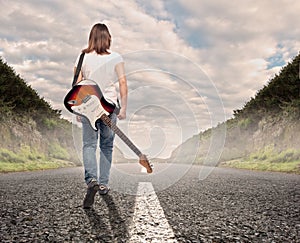 Young musician woman walking on a road