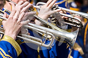 Young musicians plays on trumpets on street concert