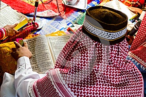 A Young Muslim Boy reading.