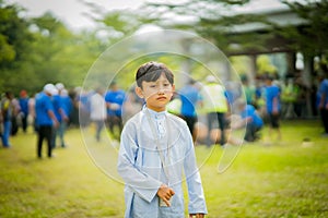 A young muslim boy at the Sacrifice ceremony in the field.