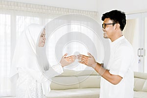 Young muslim couple forgiving each other photo