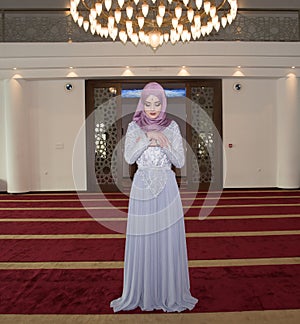 Young muslim girl pray in mosque