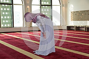 Young muslim girl pray in mosque