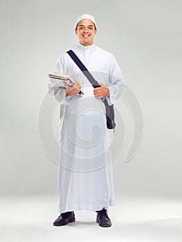 Young muslim man, islamic clothes and standing for religious studying, worship or spiritual happiness in white