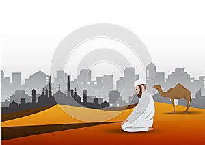 Young muslim man praying on sand background
