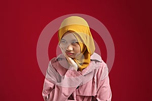 Young muslim teenage girl wearing hijab having bad mood, upset tired bored expression