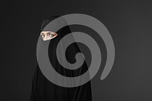 young muslim woman in black traditional