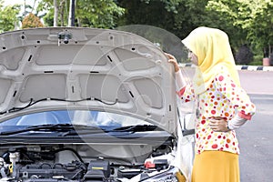 Young muslim woman checking engine