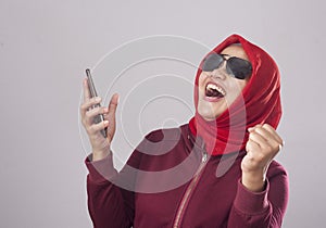 Young Muslim Woman Get Good News on Her Phone