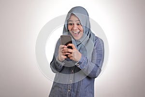 Young Muslim Woman Get Good News on Her Phone