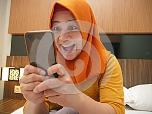 Young Muslim Woman Get Good News on Her Phone