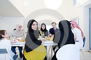 Young muslim woman having Iftar dinner with family