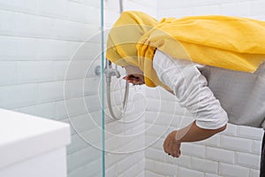 Young Muslim woman perform ablution wudhu before prayer at home