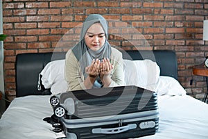 Young muslim woman praying for Allah at home