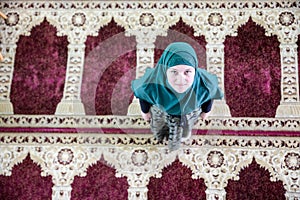 Young Muslim woman praying in the mosque