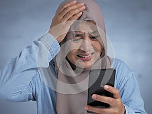Young Muslim Woman Shocked Expression, Looking at Her Phone