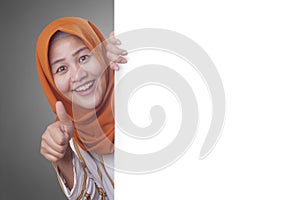 Young Muslim Woman Smiling Behind Blank White Board