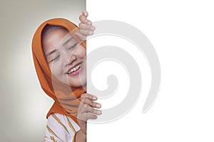 Young Muslim Woman Smiling Behind Blank White Board