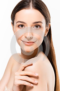 Young naked woman with perfect skin looking at camera while smiling isolated on white