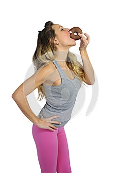 Young naughty woman biting chocolate donut happy guilty for unhealthy nutrition