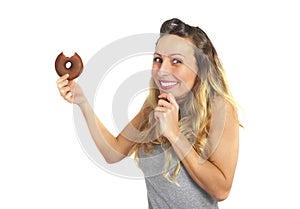 Young naughty woman eating chocolate donut happy guilty for unhealthy nutrition