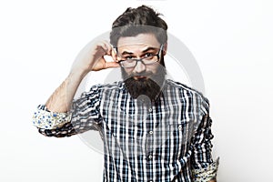 Young nerd bearded businessman touching his glasses