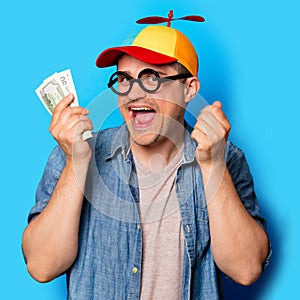 Young nerd man with noob hat holding a money photo
