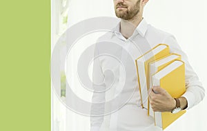 Young nerd student collage holding stack of book. Student life try to get a better grade by reading a book. learning knowledge