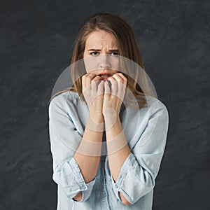 Young nervous woman biting her nails