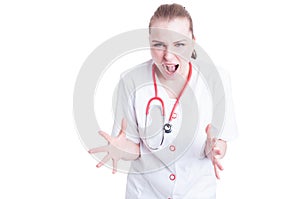 Young and nervous woman doctor with a stethoscope yell