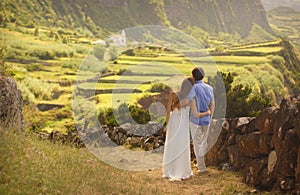 Young newly wedded hugging couple in honneymoon on Flores island, Azores photo