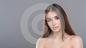 Young nude gorgeous woman portrait, grey panorama background