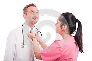 Young nurse adjusting tie of handsome medic