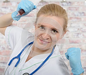 Young nurse with a big syringe