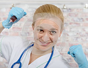 Young nurse with a big syringe