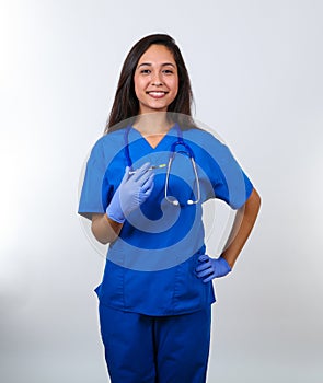 Young Nurse in Blue Scrubs Holds Vaccine