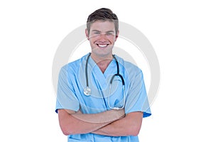 Young nurse in blue tunic with arms crossed