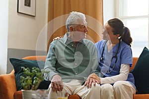 Young nurse checking elderly senior in his home.