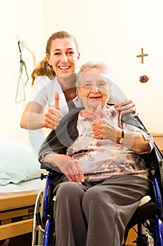 Young nurse and female senior in nursing home