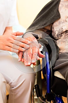 Young nurse and female senior in nursing home