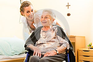 Young nurse and female senior in nursing home