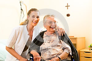 Young nurse and female senior in nursing home