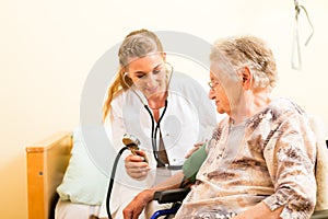 Young nurse and female senior in nursing home