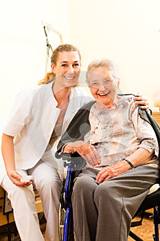 Young nurse and female senior in nursing home