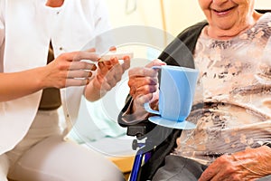 Young nurse and female senior in nursing home