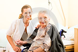 Young nurse and female senior in nursing home