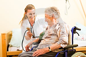 Young nurse and female senior in nursing home