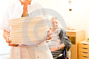 Young nurse and female senior in nursing home