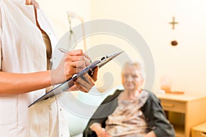 Young nurse and female senior in nursing home