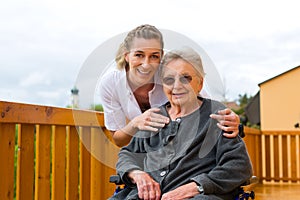 Young nurse and female senior in a wheel chair